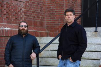 Jake McClure (left) and Mark Crockett on the steps of the former Belfast elementary school building they recently purchased along with two other partners and investors under the auspices of Midcoast Development LLC. (Photo by Wes Sterrs)