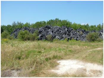 Piles of the synthetic fiber left unexposed on the back lot of an abandoned shooting range on Route 90 in Warren. (Photo by Ethan Andrews)