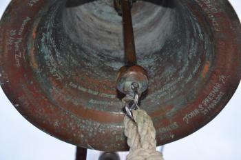The bell on the Eagle’s forecastle is engraved with the names of babies who have been baptized aboard the vessel over the years. (Photo by Lynda Clancy)