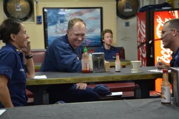 Capt. Wes Pulver (center), Executive Officer Jessica Rossi-Ochs (left) and Lt. Kris Ensley (right) at a morning weather meeting. (Photo by Lynda Clancy)