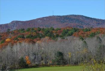Ragged Mountain, with its cellular tower, lies along the Rockport-Camden town line. (file photo by Lynda Clancy)