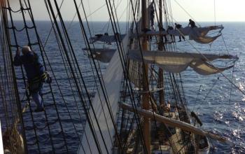 Crew climb high into the 147-foot tall masts of the Eagle to unfurl the sails before hoisting them. (Photo by Boatswain’s Mate Shelbie Smart)