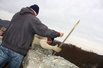 Peter Rollins provides a basic safety measure (holding onto the waistband of Tom Jackson’s jeans) while Tom reaches over to thread a bolt into a drain hole at the base of the top of the tower. (Photo by Holly S. Edwards)