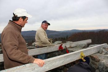 From left, Randy Stearns and Tom Jackson discuss details at the start of the star installation project Saturday. (Photo by Holly S. Edwards)