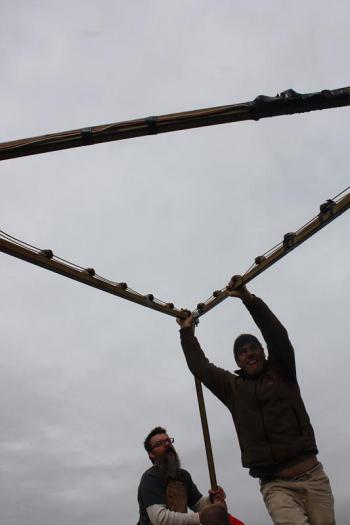 Randy Stearns begins to walk the star up, into its final upright position, while Jim Hamilton pushes it up with one of the support beams. (Photo by Holly S. Edwards)
