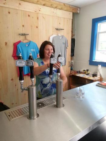 Summers when Mary Weber’s not teaching, she’s pouring. (Courtesy Monhegan Brewing Company)