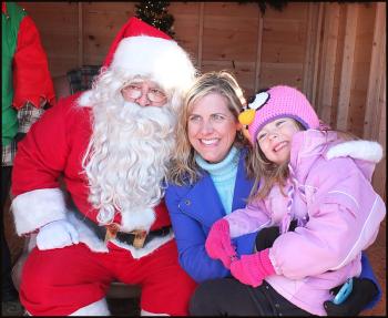Shannon Kinney and her daughter, Rachel, sit with Santa Friday afternoon. (Photo by Chris Wolf)