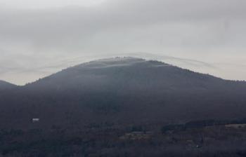 Clouds drift over a mountain to the west Saturday morning. (Photo by Holly S. Edwards)