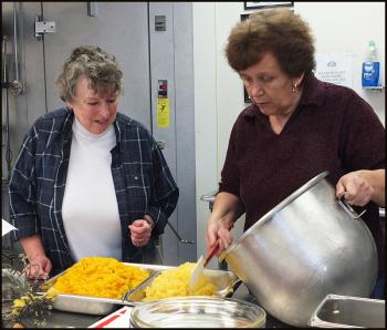 Dodie Leavitt (left) and Belinda Landre dish up squash at the American Legion Post 1.