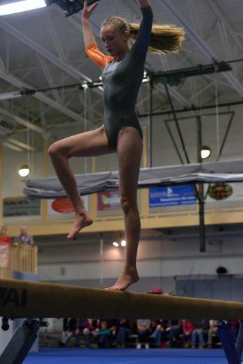 Marta Denny works the balance beam. (Photo by Ron Hawkes)