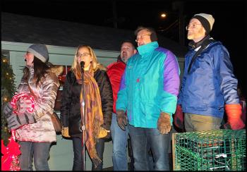 From left, Rockland City council members Elizabeth Dickerson, Louise MacLellan-Ruf, Frank Isganitis, Eric Hebert and Mayor Larry Pritchett lead the crowd in Christmas carols. (Photo by Chris Wolf)