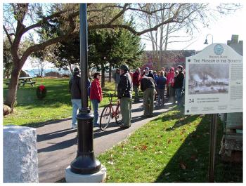 City officials placed a wreath, left, in Heritage Park to mark the moment for future generations. Along the route, Belfast historian Megan Pinette pointed out places of significance in Belfast’s past. (Photo by Ethan Andrews) City officials placed a wreath, left, in Heritage Park to mark the moment for future generations. Along the route, Belfast historian Megan Pinette pointed out places of significance in Belfast’s past. (Photo by Ethan Andrews)