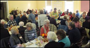 Estimated crowd of 90-plus people eat lunch at the church. (Photo by Chris Wolf)
