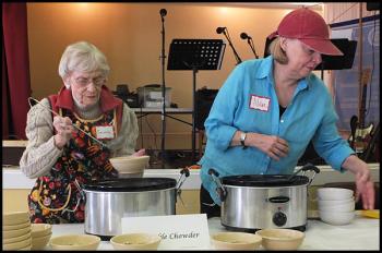 Volunteers Cornilia Ostheimer, left, and Nan Haid serve up Vegetable Chowder on Wednesday. (Photo by Chris Wolf) soup kitchen congregational church hitchings