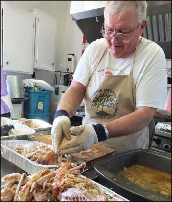 Peter Lammert picks turkey for the dinner in Thomaston.
