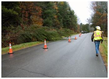 Firefighters in the town of Waldo wait for a CMP crew to clear a tree that fell across a power line on Kendall Corner Road Friday morning. (Photo by Ethan Andrews)