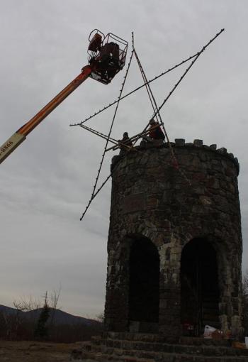 A shot to show how high the star is up on the tower, and how much easier it is to add the light bulbs now. (Photo by Holly S. Edwards)
