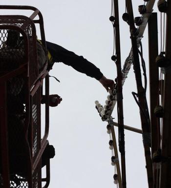 Ryan Fisher installed 100 light bulbs in the star Saturday. (Photo by Holly S. Edwards)