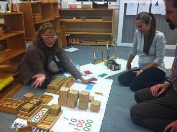 Jade Door (primary) co-teacher Katy Hall Dermott shares math materials with parents. (Courtesy Children's House Montessori School)