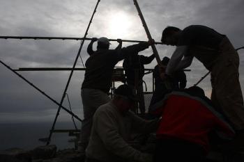 Working on top of the Mt. Battie tower to install this year’s Christmas Star, Tom Jackson, Randy Stearns, Peter Rollins, Jim Hamilton, Mary Carver, Ryan Fisher and Tom Bland spent two hours and 30 minutes connecting steel bars, securing them to the tower, hooking up the generator and installing light bulbs Saturday morning. The star will be lit for the first time this holiday season around 4 p.m. Thanksgiving Day. The gates to the top of the mountain will be open for vehicle traffic for a short time before and after the lighting. It’s a great hike up the road too, especially if you wait for dessert until you get back home. (Photo by Holly S. Edwards)