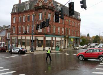 A police officer directs traffic in downtown Belfast late Friday morning during a power outage that affected 400 customers in the city. (Photo by Ethan Andrews)