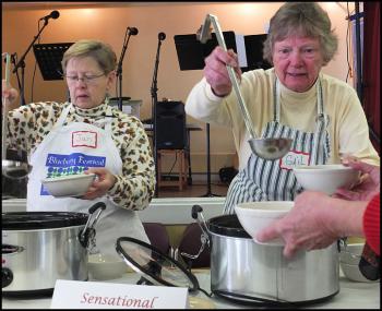 Volunteers Jan Kelsey and Gail Palmer serve up the first soup of the day, a Sensational Steak Soup, at First Congregational Church's Wednesday Soup Kitchen. (Photo by Chris Wolf)