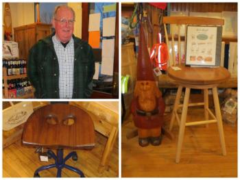 Dan Maxham stands by some of his furniture and his catalog of furniture that is featured in the store.