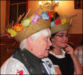 Being festive in hats are choir members Celia Johnson, of Rockland (left), and Jennifer Burns, of Thomaston