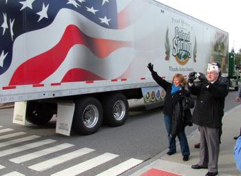 Maine First Lady Ann LePage waves to drivers from Wreaths Across America as they arrive in Belfast, Dec. 8. Next to LePage, American Legion Vice Commander Ronald Rainfrette snaps a photo. (Photo by Ethan Andrews) Maine First Lady Ann LePage waves to drivers from Wreaths Across America as they arrive in Belfast, Dec. 8. Next to LePage, American Legion Vice Commander Ronald Rainfrette snaps a photo. (Photo by Ethan Andrews)