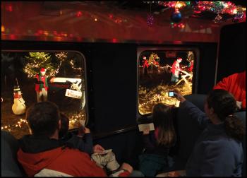 Riders of the Jingle Bell express view Santa's workshop through the train window Friday night, Dec. 6. (Photo by Chris Wolf)