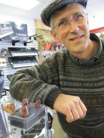 Chris Gray next to some of his picks at K2 Music. Photo by Kay Stephens
