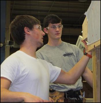 Even Myers, of Tenants Harbor, and Caleb Jacobs, of Thomaston, add finishing touches to their cottage project.