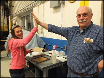 Mckayla Paulsen and Clare Stinson high-five each other after completion of Mckayla’s laser print project.