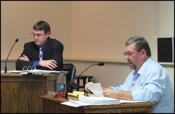City Clerk Stuart Sylvester reads the resolve before council. Acting City Manager Tom Luttrell is in the background.
