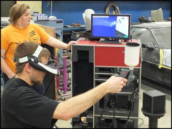 Elijah MacDougall uses a Sim computer generated: spray simulator to test his skill at applying paint.