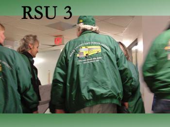 RSU 3 bus drivers congregate outside the gym at Unity Elementary School after a unanimous vote by the school board against privatizing the district’s transportation services. (Photo by Ethan Andrews)