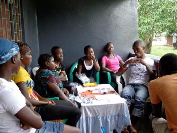Teloe Moore, right, leading a meeting for LEF students at his home. (Photo Kim Ouillette)