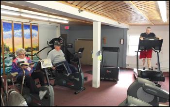 Gabriel Holmes, Frank Leary and Drew Fletcher use the cardio equipment.