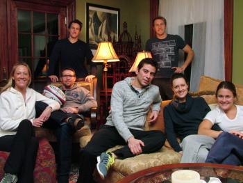 The crew of the yacht, Magic, in the living room of the Victorian home they’ve been renting in Belfast while their boat is undergoing renovations at Front Street Shipyard. Members of the group hail from as far away as Australia, South Africa and Mexico. (Photo by Ethan Andrews)