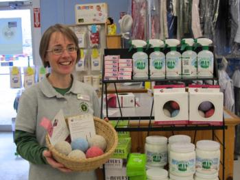 Jennifer Moore Temple, co-owner of Clean Bee Laundry, holds a basket of Maine-made Loo Hoo Wool Dryer Balls. (Photo by Kay Stephens)
