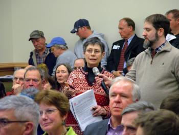 Nancy Galland of Stockton Springs addresses a panel of federal and state representatives at a public information meeting on a proposal to expand the cargo ship channel in Searsport. A number of Midcoast residents attended the meeting in Bangor, Monday night. (Photo by Ethan Andrews)