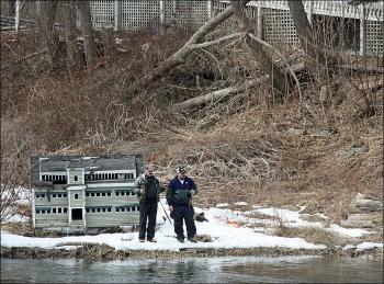 Two anglers on the shore of the mill pond above the waterfalls at the Knox Mill in Camden March 19. (Photo by Holly S. Edwards)