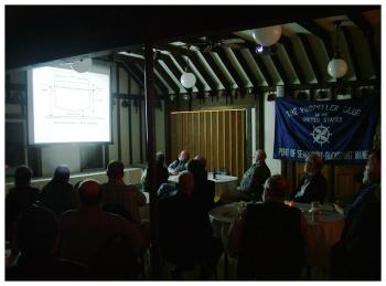 At the Shrine Club in Belfast, March 19, members of the Propeller Club watch a slide presentation on the logistics of cargo shipping at Searsport’s Mack Point. (Photo by Ethan Andrews)