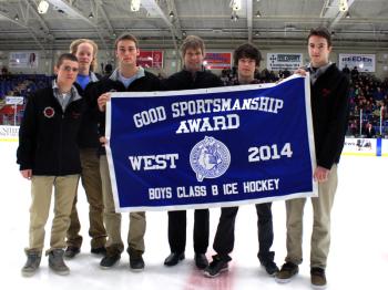 Members of the Camden Hills Regional High School ice hockey team, from left, Nick Czuchra, team co-captain Parker Lawson, team co-captain Jack Orne, head coach Karl Enroth, a player and Jet Magri hold up the Good Sportsmanship banner for Western Class B at the State Championship game at the Colisee in Lewiston March 8. (Courtesy Camden Hills Regional High School)