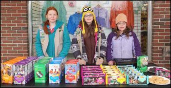Chilly weather didn’t deter Erin Corcoran, 11, of Rockland; Grace Young, 10, of Thomaston; and Melissa Leonard, 10, of Warren from selling Girl Scout cookies at Reny’s Plaza in Camden Saturday afternoon, March 22. (Photo by Chris Wolf)