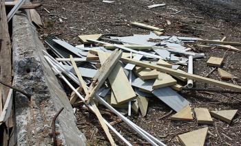 Mid-Coast Solid Waste Corp. manager Jim Guerra has started a secondary pile of non-demolition wood that people have put into the pile, and it contained a variety of disqualified components. (Photo by Holly S. Edwards)