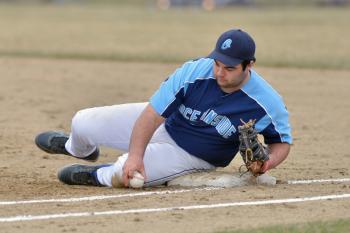 Oceanside’s Thomas Curtis uses whatever means necessary to keep the ball in the infield. (Photo by Ron Hawkes)