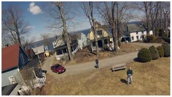 A still from one of Ned Lightner and Mark Kuzio’s videos documenting test flights with their quadcopter. Here the drone faces down toward Kuzio, right, and Lightner.