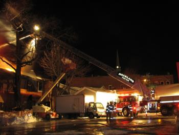 Tower Truck 3 gives mutial aid to the Grand Harbor Inn fire in Camden. (Photo by Alan Athearn)