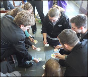 Students play a game called "Spot It" while they wait to board the ferry to Vinalhaven.